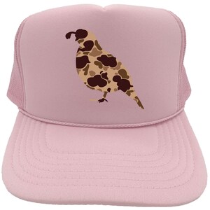 May include: A pink trucker hat with a camouflage quail design. The hat has a mesh back and a curved brim.