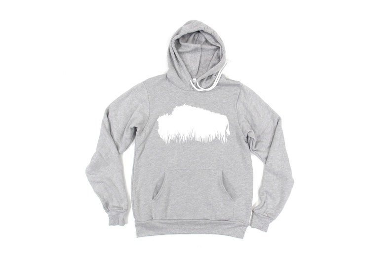 May include: A heather gray hoodie with a white graphic on the front. The hoodie has a drawstring hood, a front pocket, and long sleeves. The white graphic appears to be a stylized cloud or landscape.