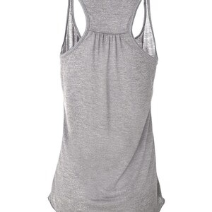 May include: A heather gray tank top with a racerback style. The tank top has a relaxed fit and a slightly longer length.