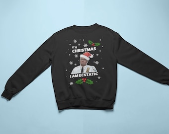 May include: Black Christmas sweater with a white snowflake pattern and a picture of a man wearing a Santa hat and a police uniform. The text on the sweater reads "It is Christmas I am ecstatic".