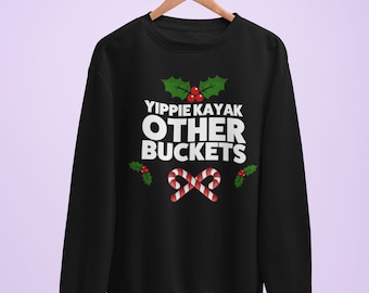 May include: Black sweatshirt with a white graphic that says "YIPPIE KAYAK OTHER BUCKETS" with a red and white candy cane design and green holly leaves.
