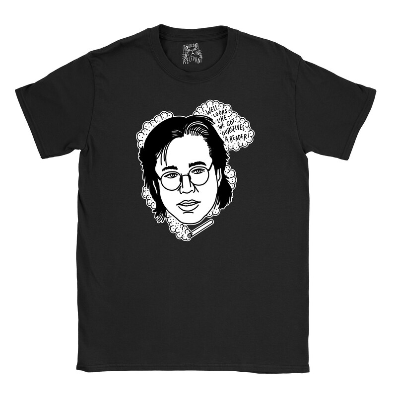 May include: Black t-shirt featuring a white illustration of a person wearing glasses and a thought bubble that says "Well looks like we got ourselves a reader!"