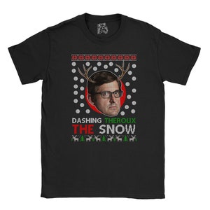 May include: Black t-shirt with a Christmas sweater design featuring a man's face with reindeer antlers. The text "Dashing Theroux The Snow" is printed on the shirt.