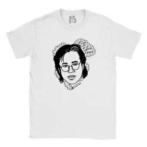 May include: White t-shirt featuring a black and white illustration of a person wearing glasses and holding a cigarette. The text "Well, looks like we got ourselves a reader!" is in a speech bubble above the person's head.