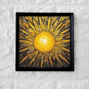May include: A framed mosaic artwork depicting a stylized sun with yellow, gold, and brown hues. The sun is surrounded by rays of light, creating a radiant effect.
