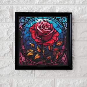 May include: A framed stained glass style print of a single red rose with green leaves and stems. The rose is surrounded by a blue and purple stained glass design.