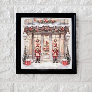 Peut inclure: Une illustration encadrée d'une devanture de magasin décorée pour Noël. La devanture a deux fenêtres avec des figurines de casse-noisettes debout devant chaque fenêtre. Les fenêtres sont décorées de couronnes et de guirlandes. La devanture est recouverte de neige.