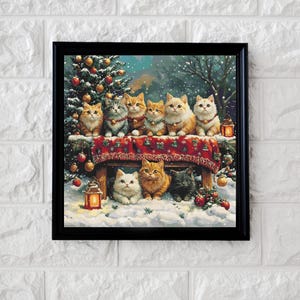 May include: A framed print featuring a festive scene with nine cats. The cats, in various colors, are gathered around a table with a red patterned cloth, in a snowy setting with a Christmas tree and lanterns. The artwork is framed in black.