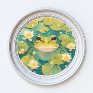 May include: A framed painting of a green frog sitting in a pond with lily pads and white flowers. The frog is smiling and has large, round eyes.