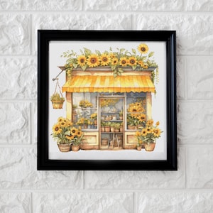 May include: A framed watercolor painting of a flower shop with a yellow awning. The shop is filled with sunflowers and other flowers. The shop is surrounded by a border of sunflowers.