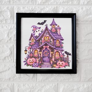 May include: A framed illustration of a purple house decorated with pink roses, featuring a ghost wearing a witch hat, two black bats, and several jack-o'-lanterns. The house has a heart-shaped window, a front door with a wreath, and glowing lanterns.