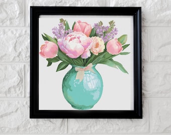 May include: A framed floral print featuring a bouquet of pink peonies, tulips, and other flowers in a turquoise vase. The vase is tied with a pink bow. The artwork is set against a white background and framed in a black frame.