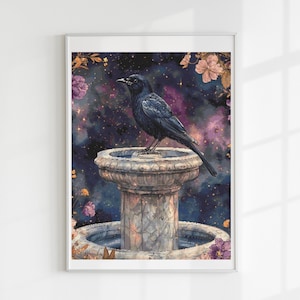 May include: A framed art print featuring a black bird perched on a stone fountain. The background is a cosmic scene with purple and blue hues, accented by floral elements. The artwork has a watercolor style.