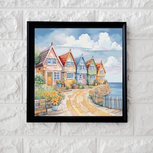 Peut inclure: Une peinture encadrée à l'aquarelle représente une rangée de cottages colorés au bord de la mer. Les maisons ont des toits rouges, roses, bleus, verts et oranges. Un chemin de pierre mène aux cottages, avec la mer et le ciel en arrière-plan. Des fleurs jaunes sont au premier plan.