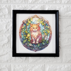 May include: A framed print of a colorful illustration of a cat sitting in a stained glass window with a leafy design. The cat is orange and white with green eyes.