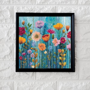 Könnte beinhalten: Ein quadratisches gerahmtes Wandbild mit einem lebendigen Blumenmotiv, das verschiedene bunte Blüten in Orange, Pink, Gelb und Violett vor einem strukturierten blau-türkisfarbenen Hintergrund mit vertikalen weißen Farbstreifen zeigt.