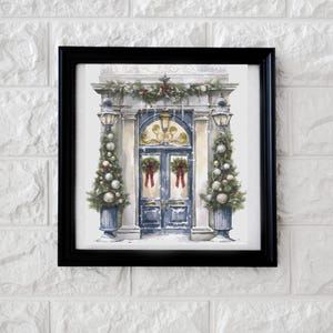 May include: A framed watercolor print of a festive blue door with wreaths and red bows. The door is flanked by Christmas trees in blue planters and topped with garland. The print is set against a white brick wall.