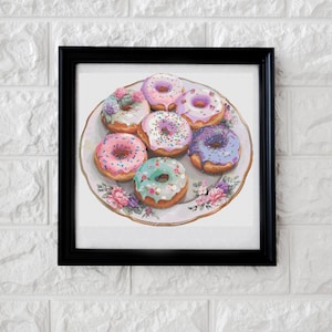 May include: A framed print featuring a plate of colorful donuts. The donuts are decorated with various frostings and sprinkles, including pink, purple, and blue. The plate has a floral design, and the frame is black.