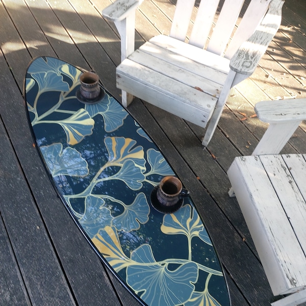 Surfboard shaped accent table with gingko tree leaves pattern: blue-turquoise, gold small coffee table with leaf print for nature home decor