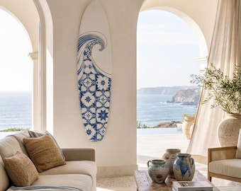 May include: A surfboard mounted on a wall featuring a white background with a blue and white wave graphic at the top and a blue and white geometric tile pattern covering the lower portion of the board's surface.