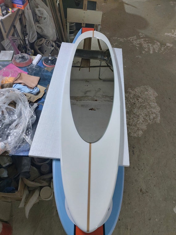 Wall mirror in wooden surfboard shaped frame
