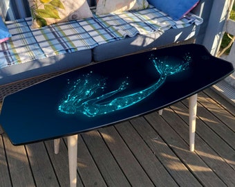 Fish surfboard inspired wooden surf table with mermaid print: black surfboard coffee table with blue mermaid-girl pattern for nautical decor