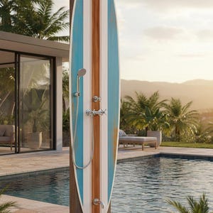 May include: An outdoor shower unit featuring a vertical surfboard-shaped panel with blue, white, and wood-grain stripes. The fixture includes a chrome overhead shower head, a handheld shower wand on a flexible hose, cross-handle valves, and a foot faucet.