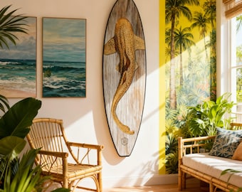 May include: A surfboard featuring a detailed illustration of a spotted shark on a weathered wood-grain background, mounted vertically on a wall. The board has a pointed nose and a rounded tail, with a black border framing the entire shape.
