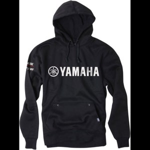 May include: Black hooded sweatshirt with a white Yamaha logo and a small red and white stripe on the left sleeve.