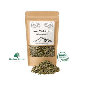 May include: A brown kraft paper stand-up pouch containing dried Sweet Violet Herb (Viola odorata). The white label features a mountain graphic, the text "Sweet Violet Herb (Viola odorata)", and the website "www.treeoflove.shop". A pile of the dried herb sits in front.