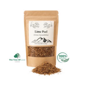 Op de afbeelding: Een bruine kraftpapieren zak met gedroogde limoenschil, gelabeld met de tekst Lime Peel (Citrus Aurantiifolia), een bergafbeelding en de website www.treeoflove.shop. Een kleine hoop van de bruine, korrelige gedroogde limoenschil ligt ervoor.