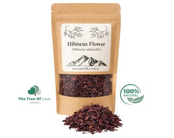 May include: A brown paper pouch containing dried dark red hibiscus flowers. The white label features the text Hibiscus Flower (Hibiscus sabdariffa), a mountain graphic, and the website www.treeoflove.shop. A pile of loose dried flowers sits in front.
