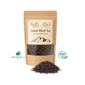 May include: A brown kraft paper pouch containing Assam Black Tea with a clear window showing dark tea leaves. The label features a mountain illustration, the text Assam Black Tea, www.trecoflove.shop, and a 100% Natural logo.