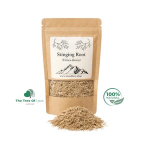 May include: A brown paper pouch containing dried Stinging Root (Urtica dioica) with a white label featuring a mountain illustration, the text www.treeoflove.shop, and a 100% natural logo. A pile of the light brown, fibrous root sits in front of the pouch.