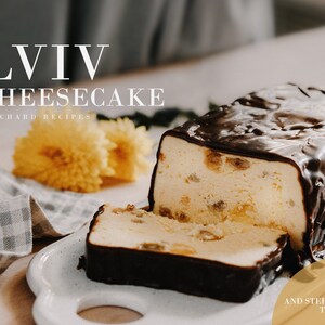 May include: A Lviv Cheesecake recipe with a step-by-step tutorial. The cheesecake is topped with a layer of chocolate and is sliced on a white plate. The cheesecake is on a wooden table with a yellow flower in the background.