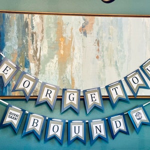 May include: A blue and white banner with the words "Georgetown Bound" and "Hoya Saxa!" hanging on a wall. The banner is made of paper and has a scalloped edge.