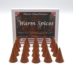 May include: A box of "Nectar Cloud Incense" with the text "Warm Spices" is displayed with 20 brown incense cones. The box lists ingredients like Cassia, Clove, and Ginger. The product is handmade in Oregon, USA.