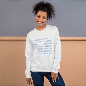 May include: White sweatshirt with a blue design of binary code. The code reads: 01101000 011100101 01101100 01101100 01101111 00100000 01110111 01101111 01110010 01101100 01100100 00100000 00111010 00101001
