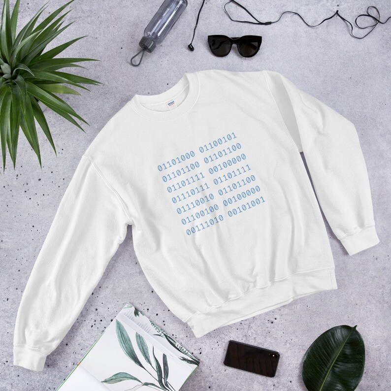 May include: White sweatshirt with a blue design of binary code on the front. The code reads: 01101000 01100101 01101100 01101100 01101111 00100000 01110111 01101111 01110010 01101100 01100100 00100000 00111010 00101001