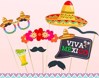 May include: A collection of party photo booth props on sticks, including a large yellow sombrero, a floral crown, black mustaches, a lime-topped cocktail glass, sombrero-shaped glasses, and a sign with the text VIVA MÉXICO and maracas.