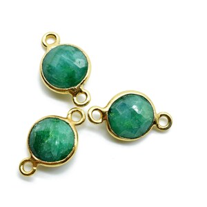 May include: Three gold-toned connector charms with green gemstone cabochons. Each charm has two jump rings for attaching to jewelry.