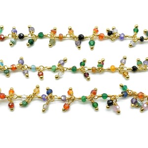 May include: A gold chain with colorful gemstone beads. The chain is made of small, delicate links and features a variety of beads in different colors and shapes.