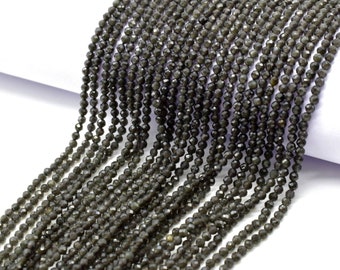 May include: A strand of dark gray faceted gemstone beads. The beads are small and uniform in size, and they have a smooth, polished finish.