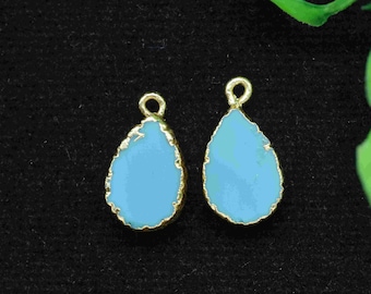 May include: Two gold-rimmed teardrop-shaped pendants with a light blue enamel finish.