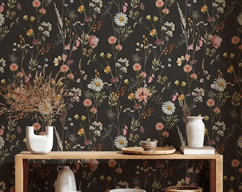 May include: A dark charcoal wallpaper featuring a repeating pattern of wildflowers, including white daisies, pink blossoms, and yellow buds on thin green stems. The wallpaper serves as a backdrop for a wooden shelf with ceramic decor.