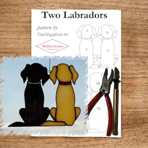 May include: A stained glass pattern of two Labrador dogs, one black and one yellow, with a numbered template for cutting the glass. The pattern is titled "Two Labradors" and is by TimeMagnificentArt. The image also includes a pair of glass cutters and a glass scoring tool.