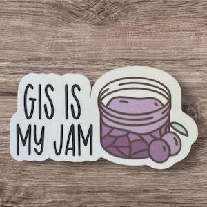 May include: A white sticker with the text "GIS IS MY JAM" in black lettering. A purple jar of jam with a white lid and purple berries is pictured next to the text.