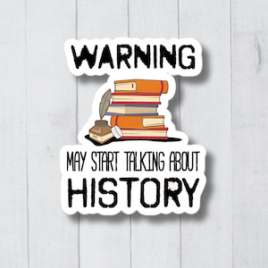 May include: Warning sticker with a stack of books, an inkwell, and a quill pen. The text reads "Warning May Start Talking About History".