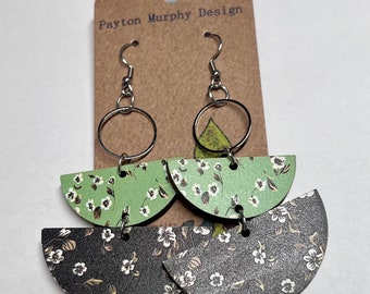 May include: A pair of green and black floral patterned wood earrings with silver hooks and rings. The earrings are on a brown card with the text "Payton Murphy Design".