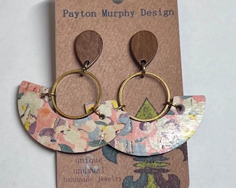 May include: A pair of handmade earrings featuring a floral pattern on a pink and white background. The earrings are made of wood and have a brass hoop. The earrings are displayed on a card with the text "Payton Murphy Design, unique unusual handmade jewelry".